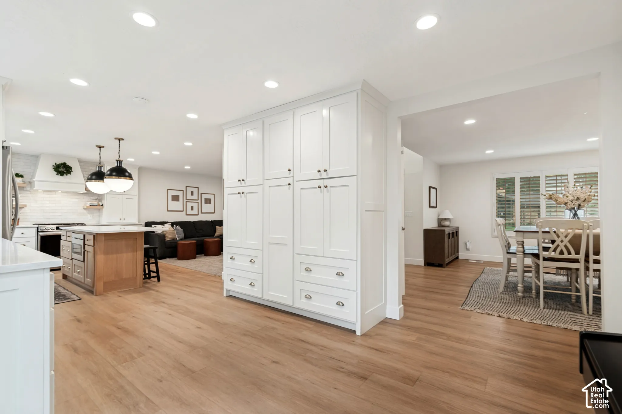 White shaker cabinetry with ample storage and silver hardware
