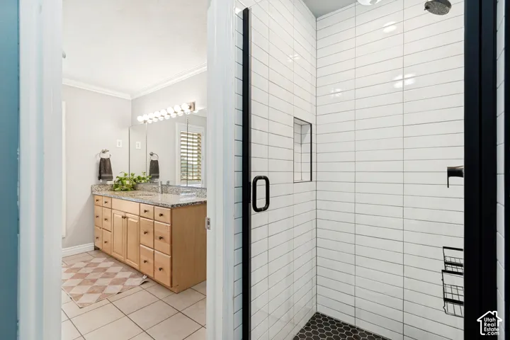 Walk-in shower with white subway tile surround and black hexagon mosaic tile floor