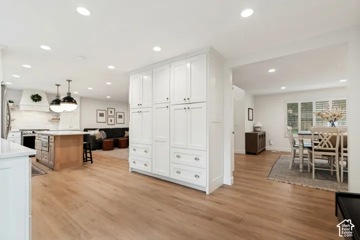White shaker cabinetry with ample storage and silver hardware