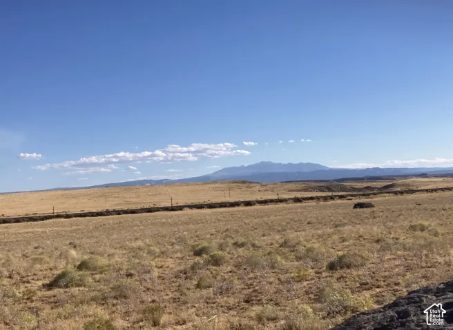 Expansive arid landscape with distant mountains under a clear sky