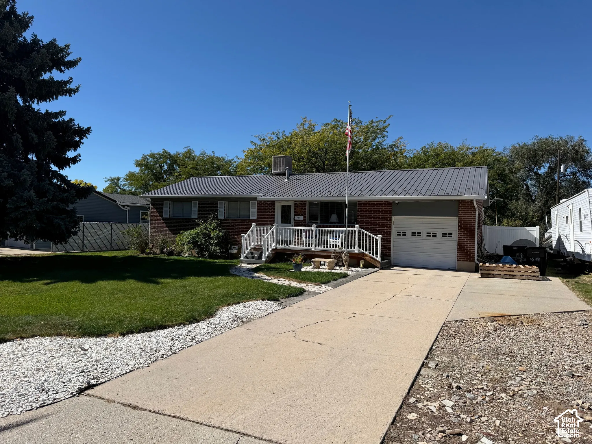 Brick exterior with a gray metal roof