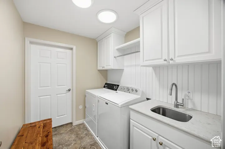 White shaker-style cabinetry with chrome hardware, beadboard wall paneling, stainless steel sink with gooseneck faucet, light-toned countertop, and recessed lighting