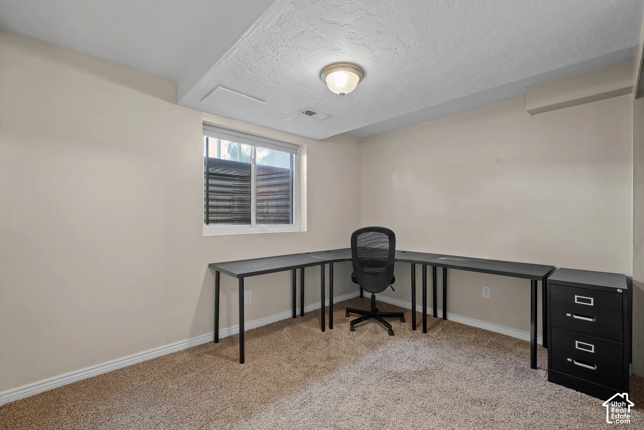 Recessed window with white trim, tan wall paint, textured ceiling, and flush mount lighting