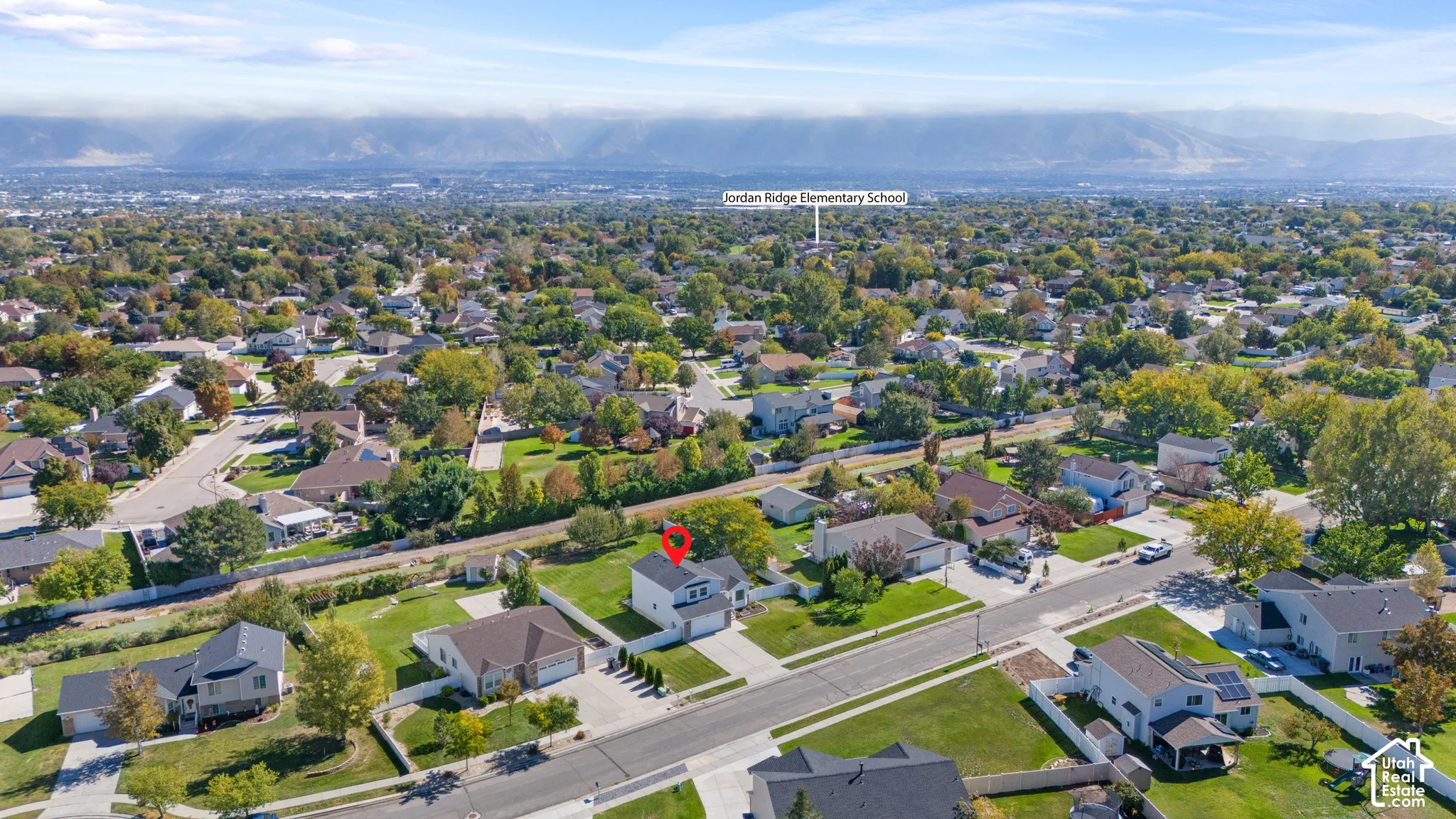 Residential neighborhood setting with established trees and distant mountain range