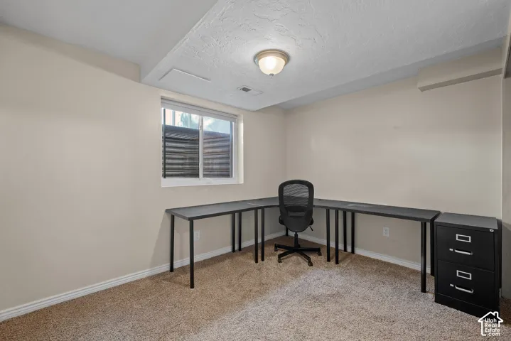 Recessed window with white trim, tan wall paint, textured ceiling, and flush mount lighting