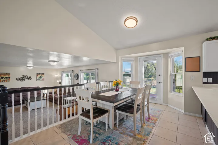 Tiled kitchen area with bay windows and a glass-paneled door