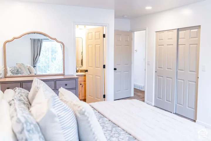 Recessed lighting, white paneled doors, and bi-fold closet doors