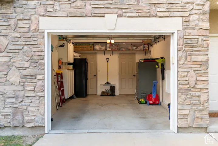 Garage interior with concrete flooring, two access doors, and recessed lighting