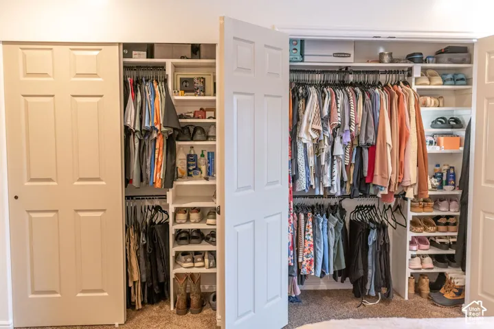 Built-in closet organization system featuring shelving and multiple hanging rods