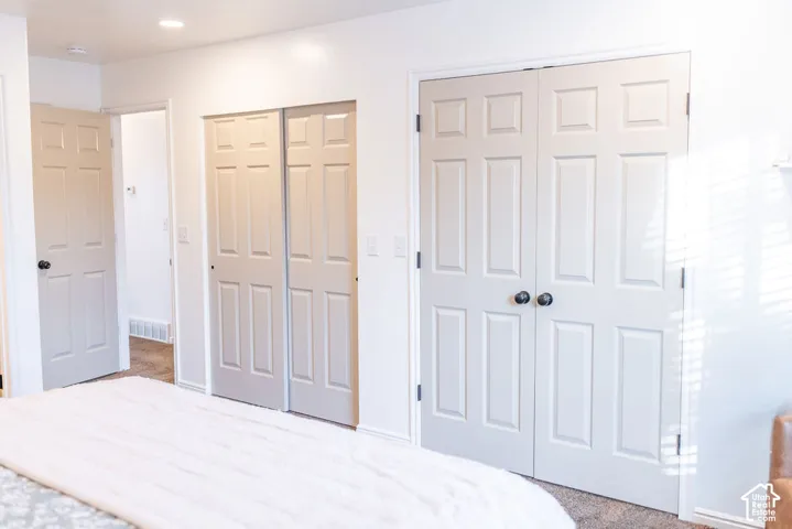 Recessed ceiling lighting, paneled interior doors, and carpeted flooring