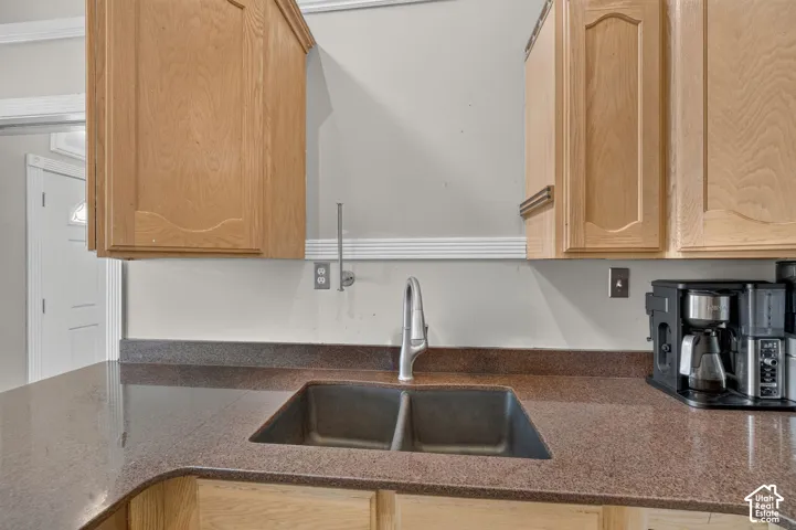 Dual basin sink with a single-handle faucet, set into a speckled countertop