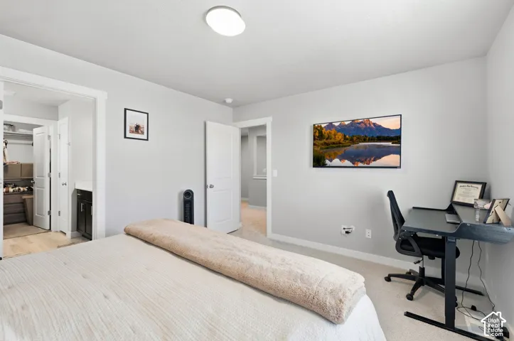 White walls with carpet flooring, a flush-mount ceiling light fixture, and a wall-mounted display