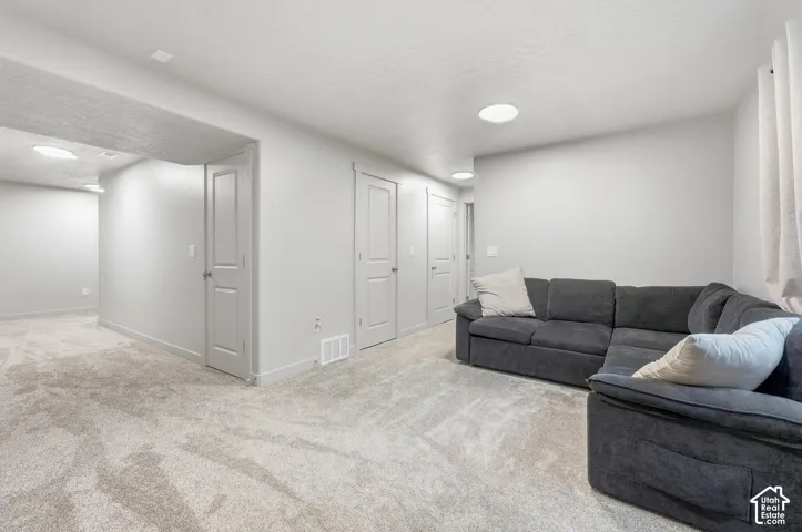 Wall-to-wall carpeting and neutral wall tones create a versatile interior
