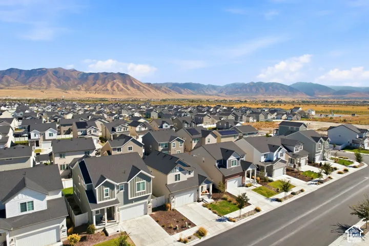 Residential development featuring multiple properties with two-story designs, attached garages, and paved driveways