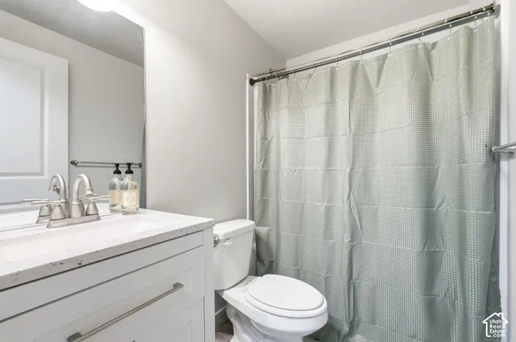 White vanity with a light-colored countertop and brushed nickel hardware
