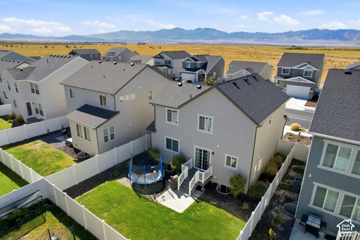 Two-story residence featuring a gray exterior and a dark roof