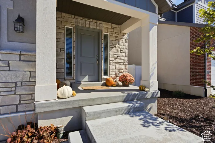 Stone veneer facade with stucco accents and a covered front entry
