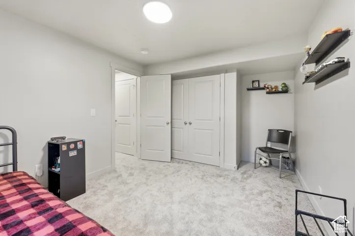 Carpeted flooring, recessed lighting, white interior doors, and built-in shelving