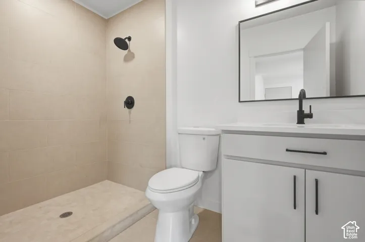 Walk-in shower with matte black fixtures and light-toned tile