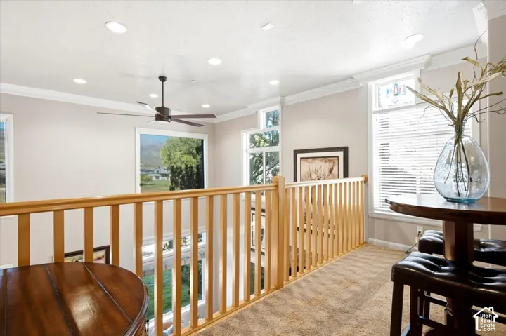 Loft area featuring light wood-finish railings, recessed lighting, ceiling fan, and carpeted flooring