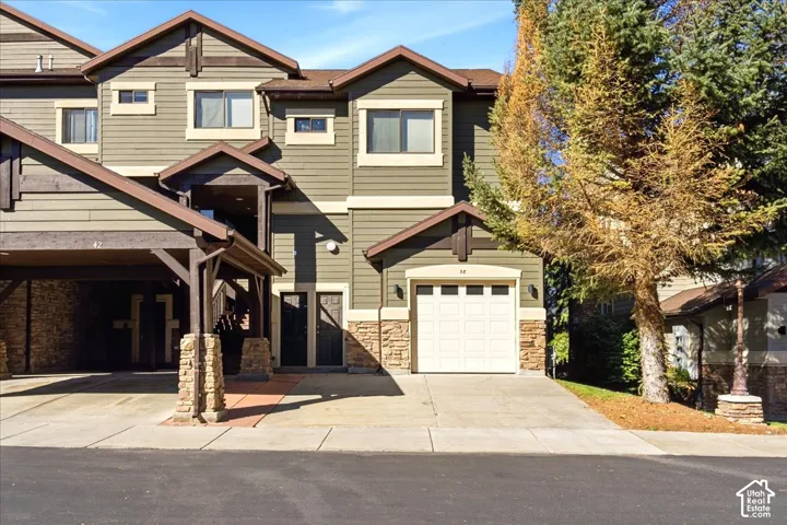 Exterior featuring multi-tone siding, stone accents, and a covered entryway