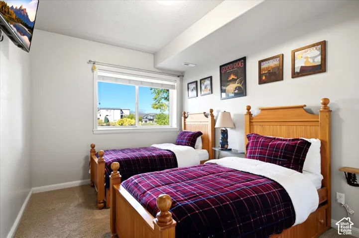 Recessed lighting, light-toned walls, and carpeted flooring