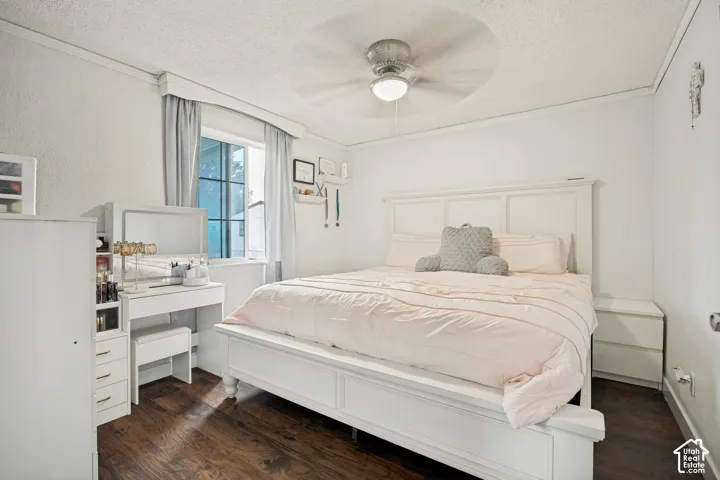 Wood-finish flooring, white walls, and a ceiling fan with integrated lighting