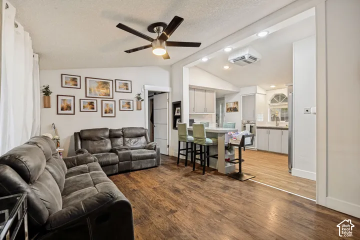 Wood-finish flooring throughout, with a ceiling fan in the living area