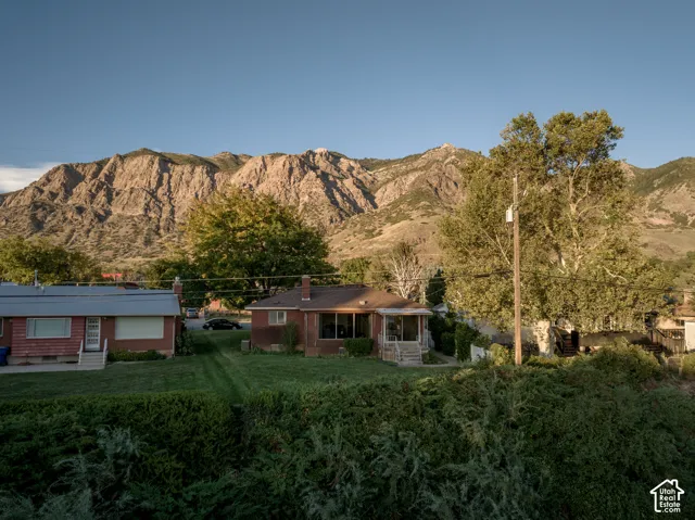 Brick residence set on expansive grounds with mature landscape plantings, including deciduous and evergreen trees