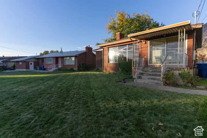Brick exterior with large windows and covered entry