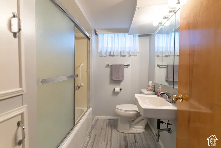 Wall-mounted sink with chrome faucet, vanity lighting, and a mirrored medicine cabinet