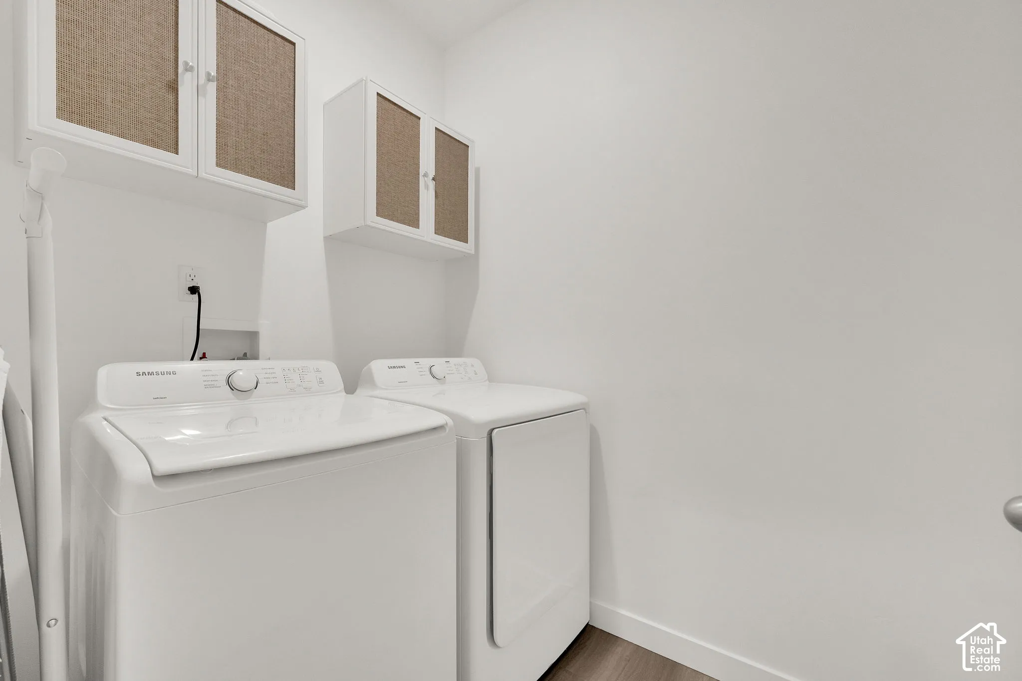 Main floor laundry room featuring white cabinetry with textured panel inserts.