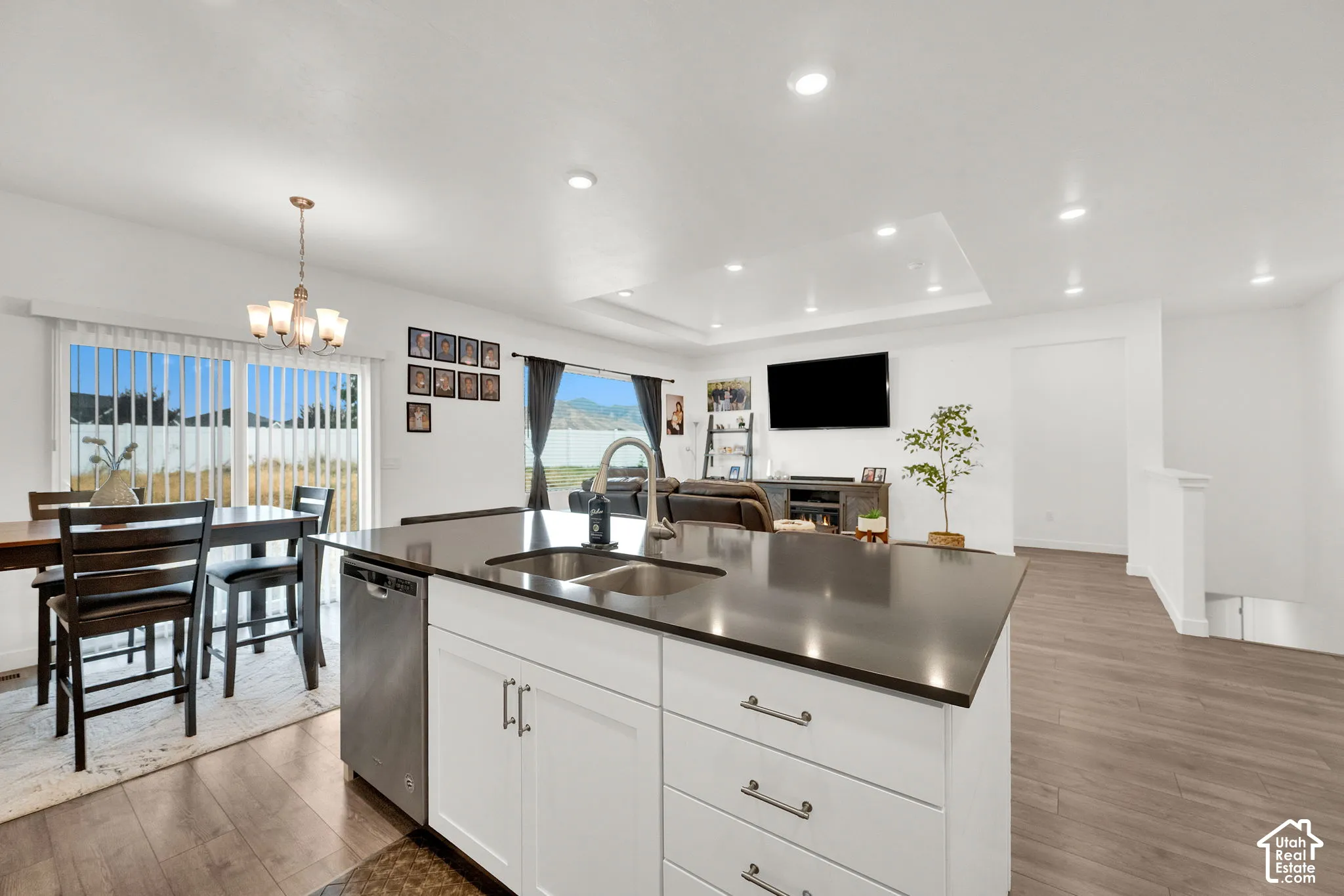 Kitchen island with a dark countertop and stainless steel sink