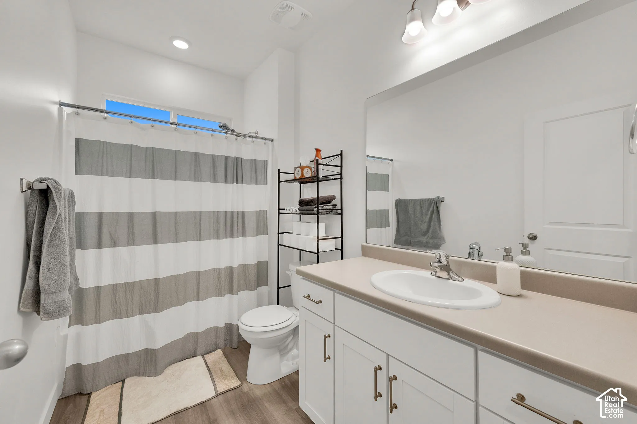 Guest bathroom with white vanity with integrated sink.