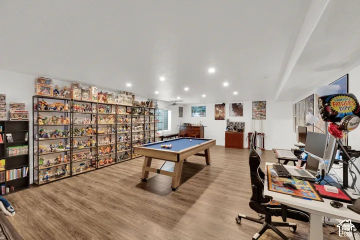 Expansive recreation room featuring wood-finish flooring.