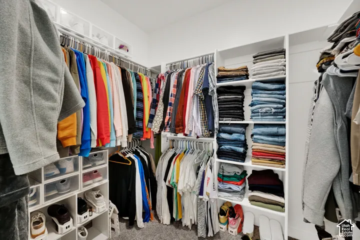 Custom closet system featuring built-in shelving, hanging rods, and integrated shoe storage