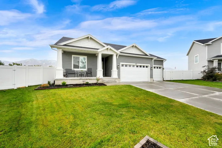 Ranch-style exterior with gray siding, white trim, and a covered porch