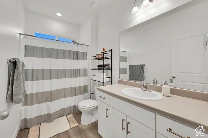 Guest bathroom with white vanity with integrated sink.