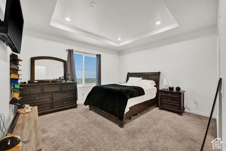 Primary suite with recessed lighting & tray ceiling.
