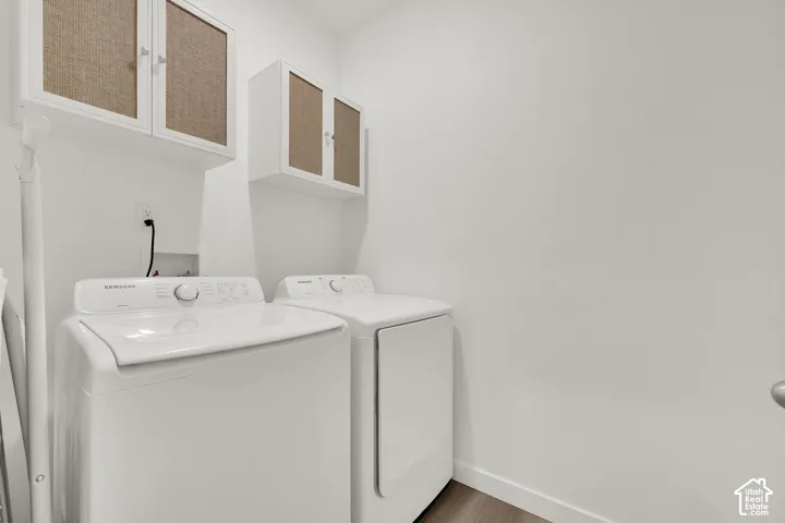 Main floor laundry room featuring white cabinetry with textured panel inserts.