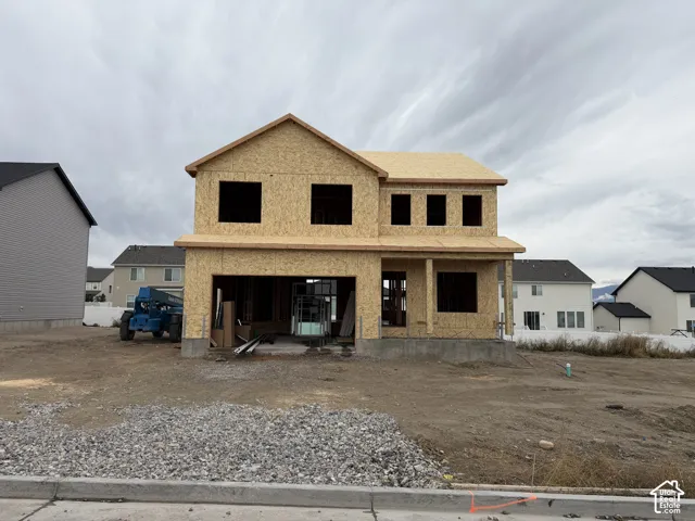Two-story residential construction with exposed wood sheathing