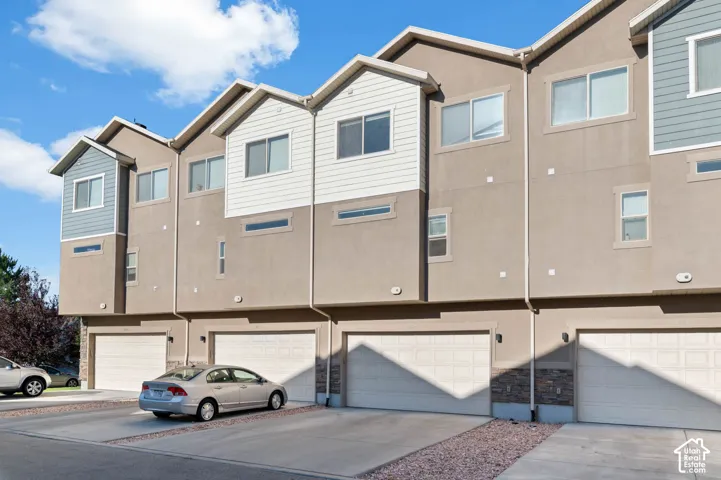 Townhome exterior featuring individual garage access