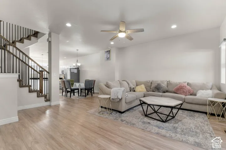 Open-concept living area featuring wood-finish flooring, recessed lighting, and a ceiling fan