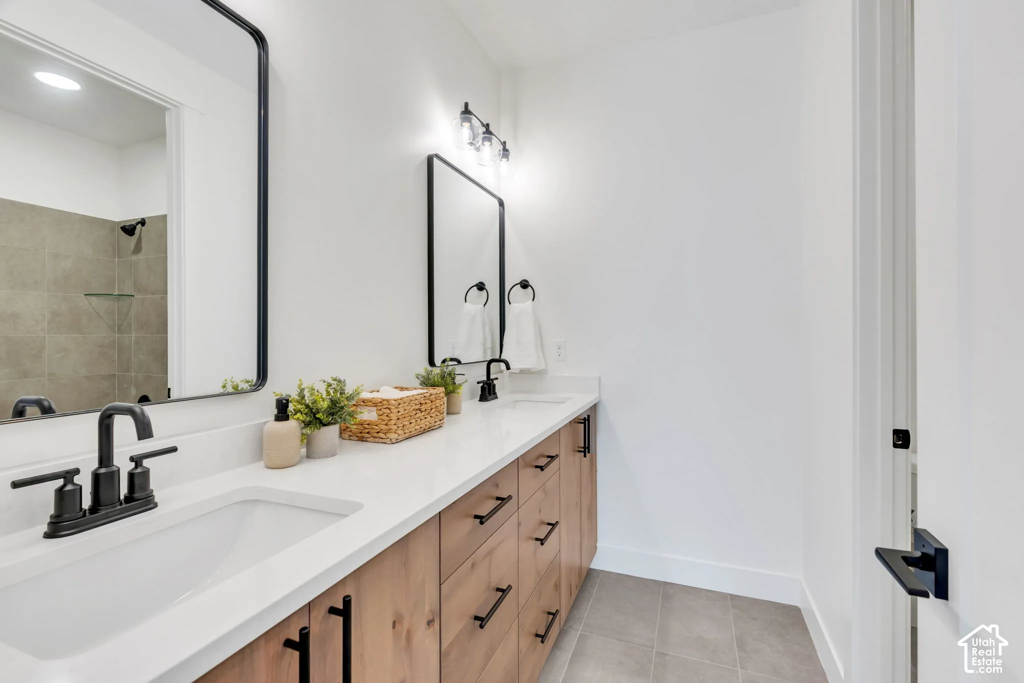Dual sink vanity with wood-finish cabinetry and quartz countertops