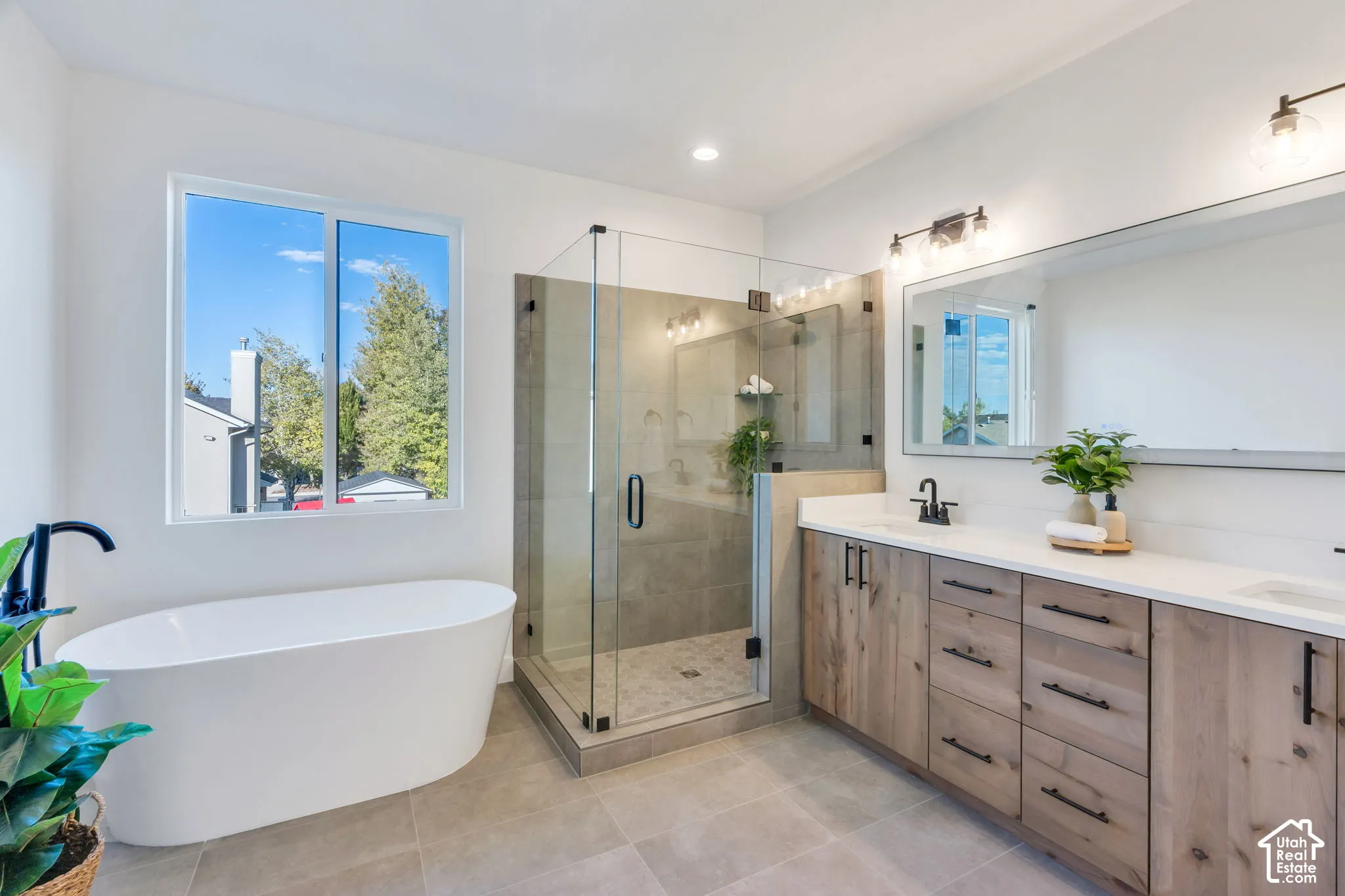 Freestanding soaking tub with a floor-mounted matte black faucet
