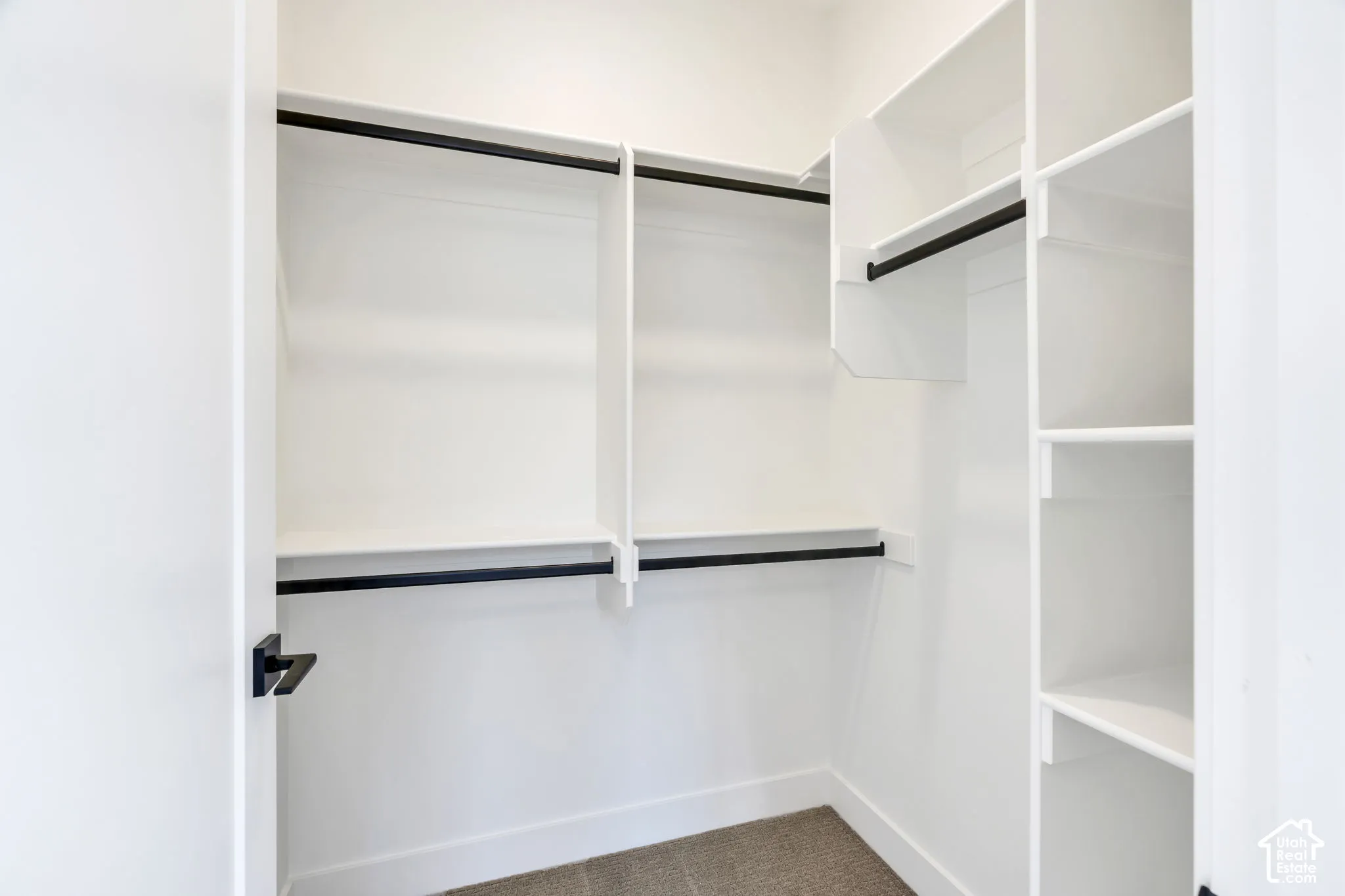 Built-in closet shelving system with multiple storage racks and hanging rods