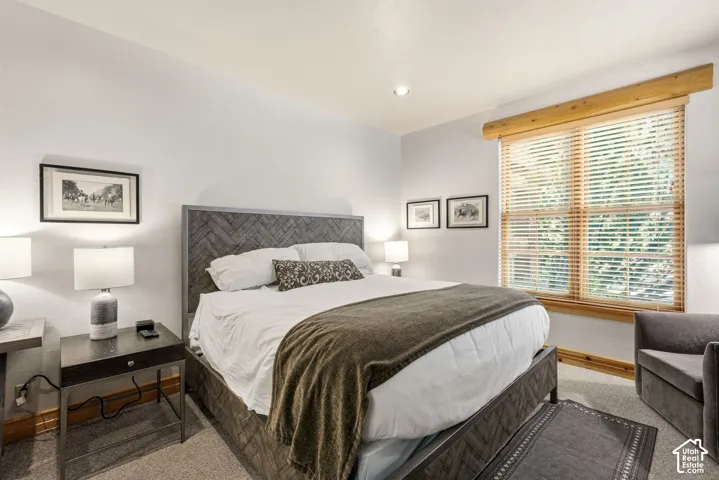 Recessed lighting, wood-finish window frame, and neutral wall tones
