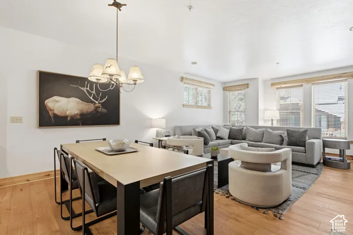 Wood-finish flooring throughout, complemented by recessed lighting and multiple windows with wooden blinds