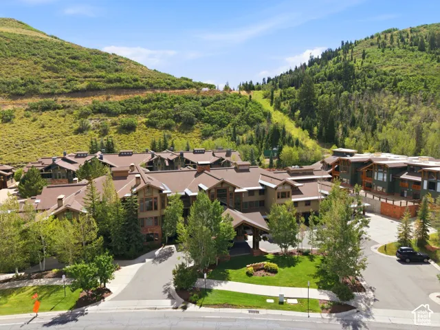 Multi-level property with expansive rooflines, surrounded by mature trees and natural landscaping