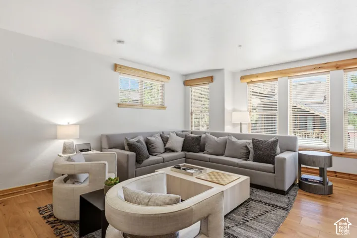 Hardwood flooring, recessed lighting, and multiple windows with wood trim